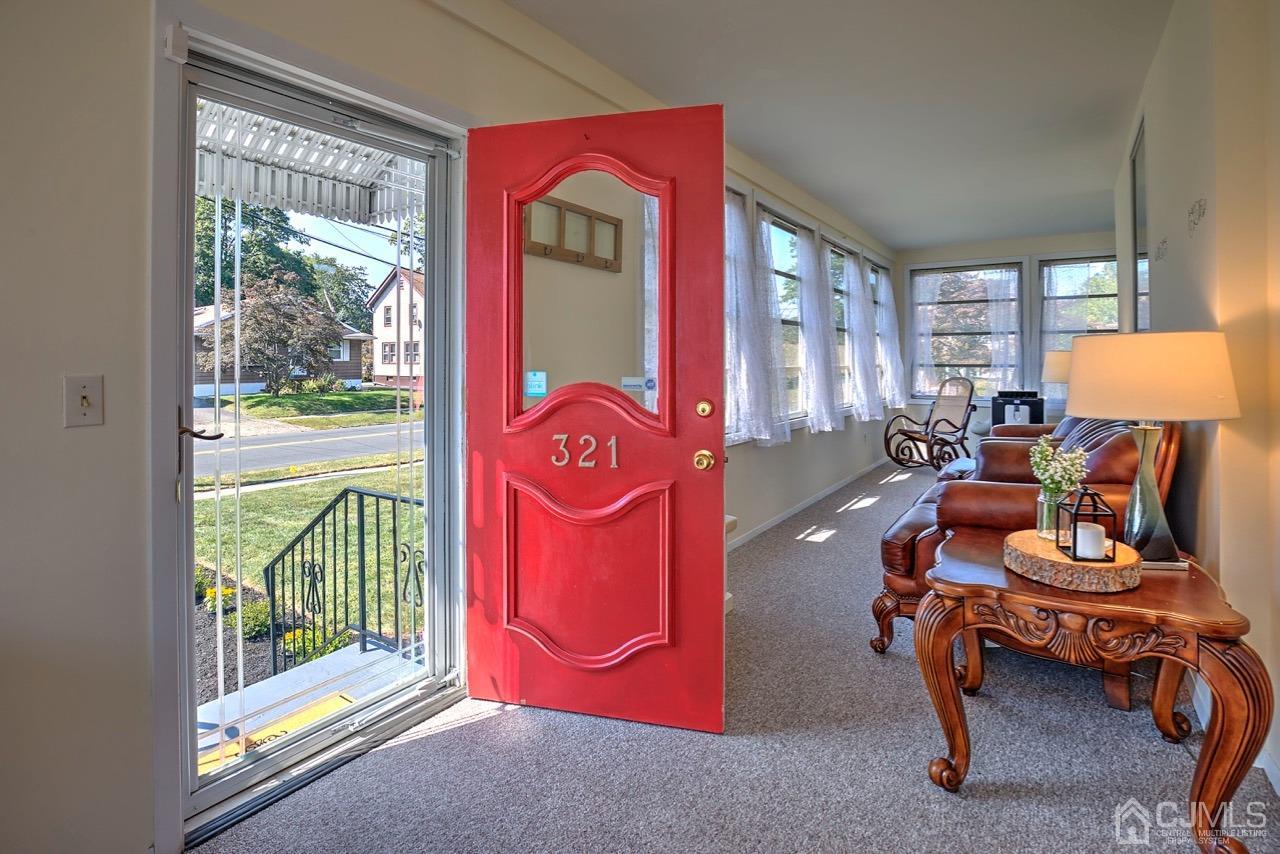 321 New Market Road Dunellen, NJ 08812 - Photo 3 of 31 a living room with furniture and a floor to ceiling window