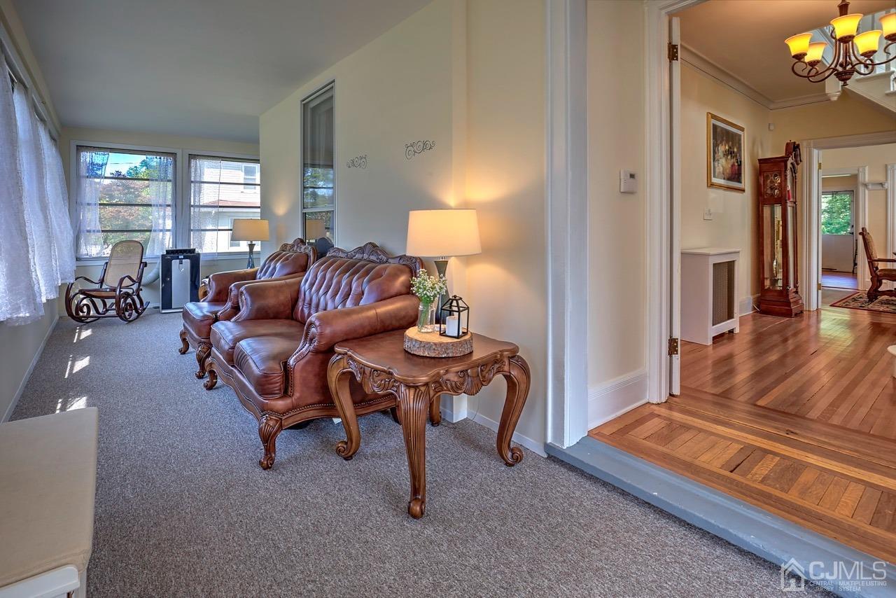 321 New Market Road Dunellen, NJ 08812 - Photo 5 of 31 a living room with furniture and a chandelier