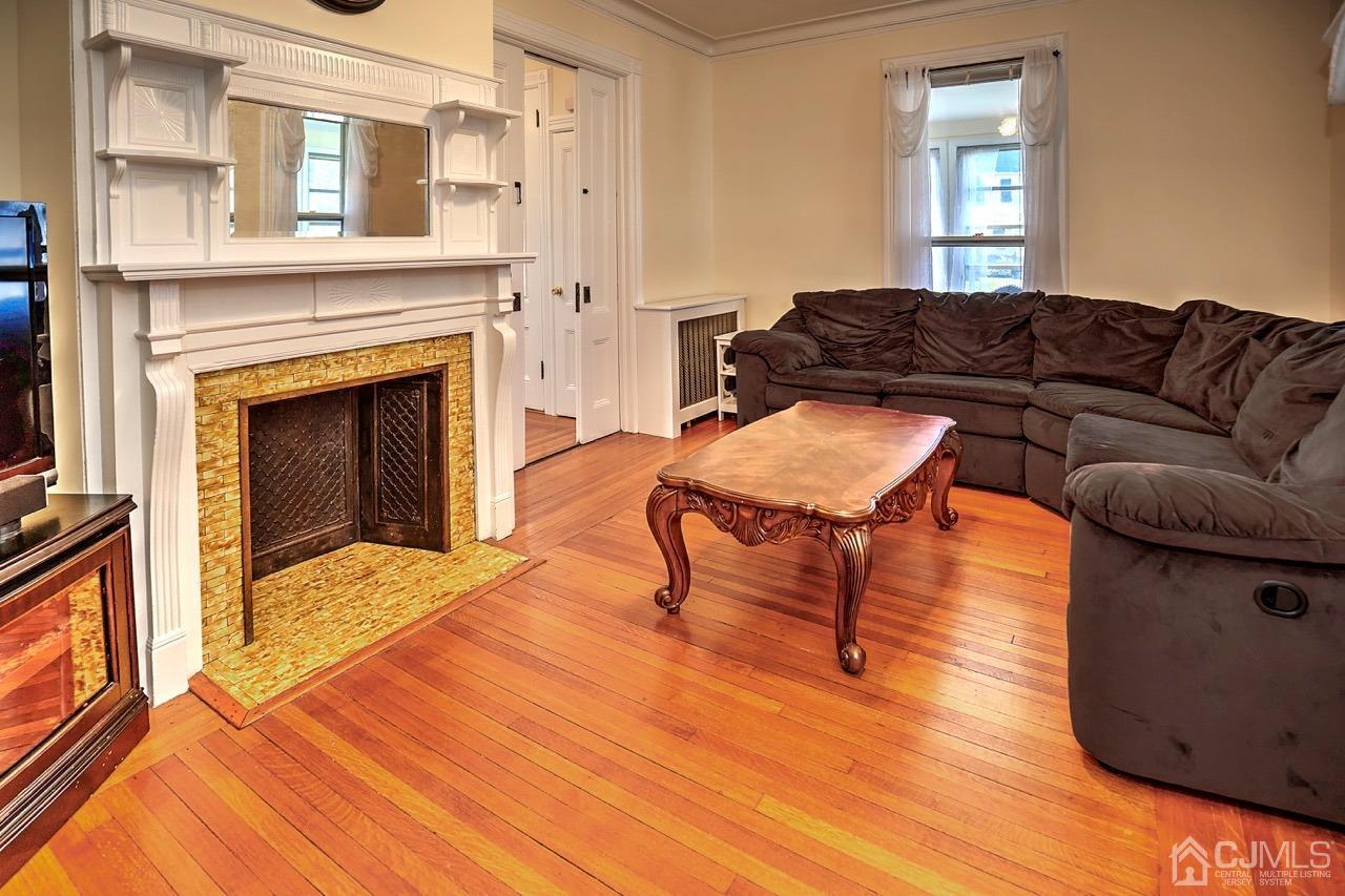 321 New Market Road Dunellen, NJ 08812 - Photo 8 of 31 a living room with furniture and a fireplace