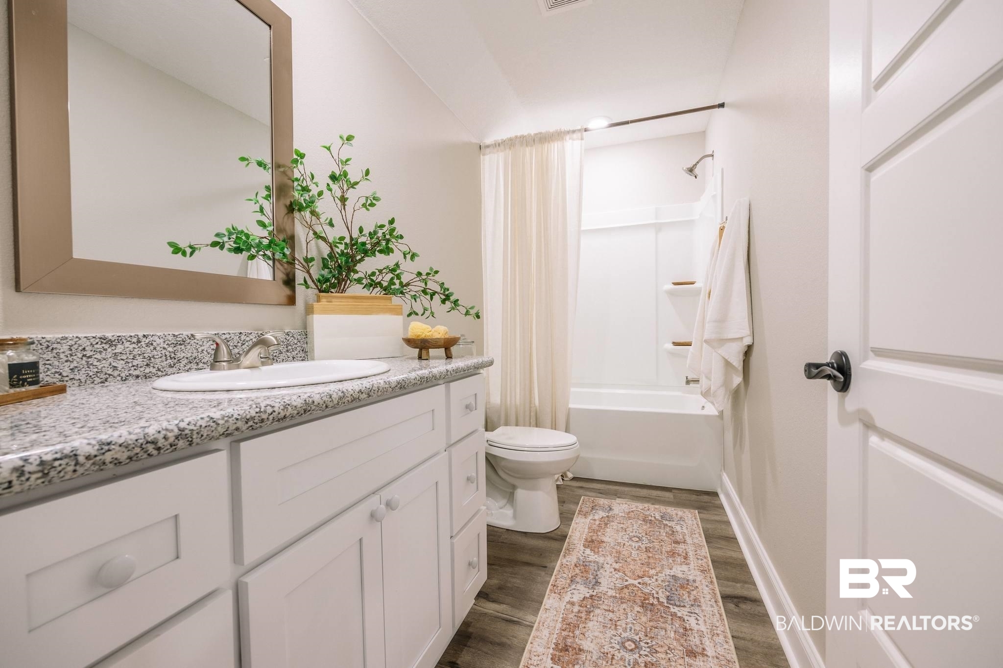 12918 Flanagan Street Elberta, AL 36530 - Photo 16 of 33 Full bathroom featuring a white vanity with a speckled countertop, undermount sink, and brushed nickel faucet