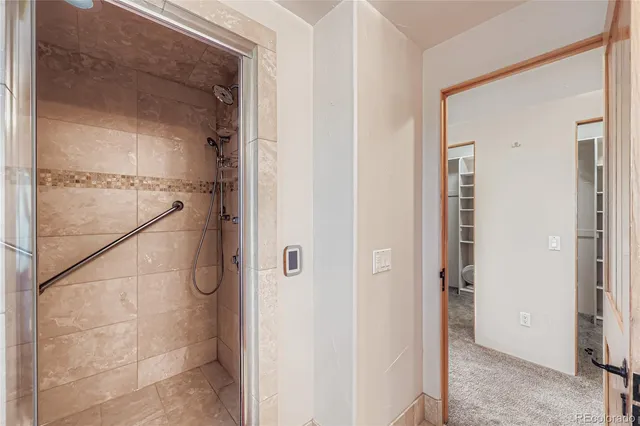 a bathroom with a glass shower door