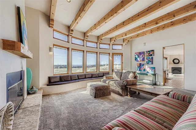 a living room with furniture and a floor to ceiling window