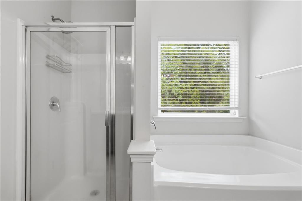 123 Renford Road Ball Ground, GA 30107 - Photo 17 of 27 a bathroom with a bathtub and shower