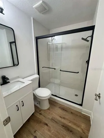 a bathroom with a toilet sink and shower