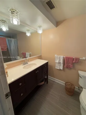 a bathroom with a sink vanity and a mirror