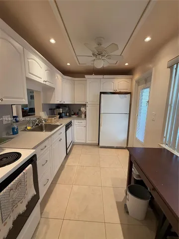 a kitchen with a sink appliances and cabinets