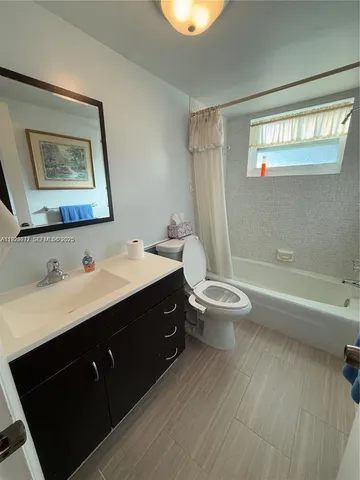 a bathroom with a double vanity sink toilet and a bathtub