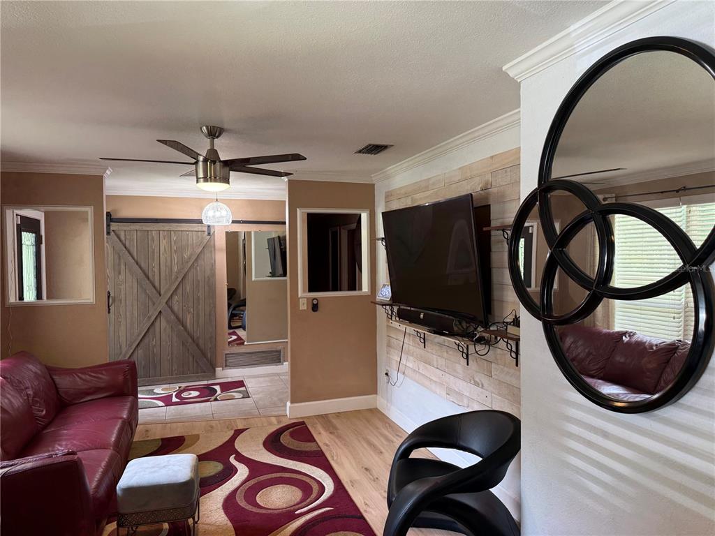 7713 Southwest 8th Avenue Gainesville, FL 32607 - Photo 12 of 32 a living room with furniture and flat screen tv