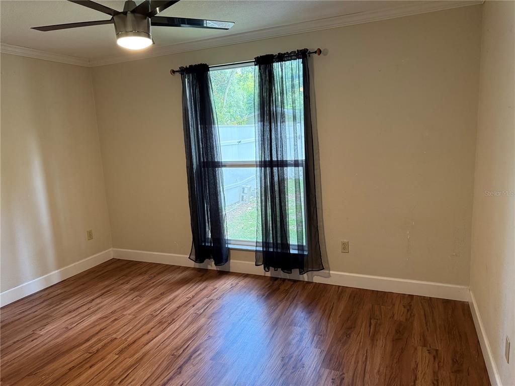 7713 Southwest 8th Avenue Gainesville, FL 32607 - Photo 16 of 32 an empty room with wooden floor and windows