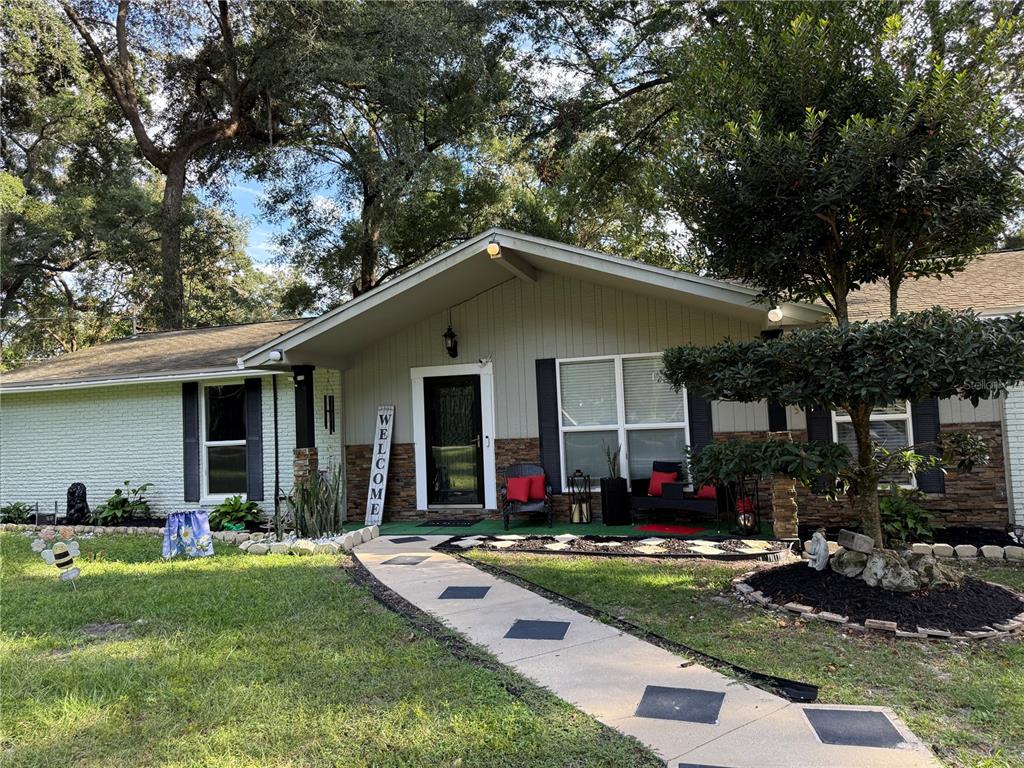 7713 Southwest 8th Avenue Gainesville, FL 32607 - Photo 3 of 32 a front view of house with yard and outdoor seating