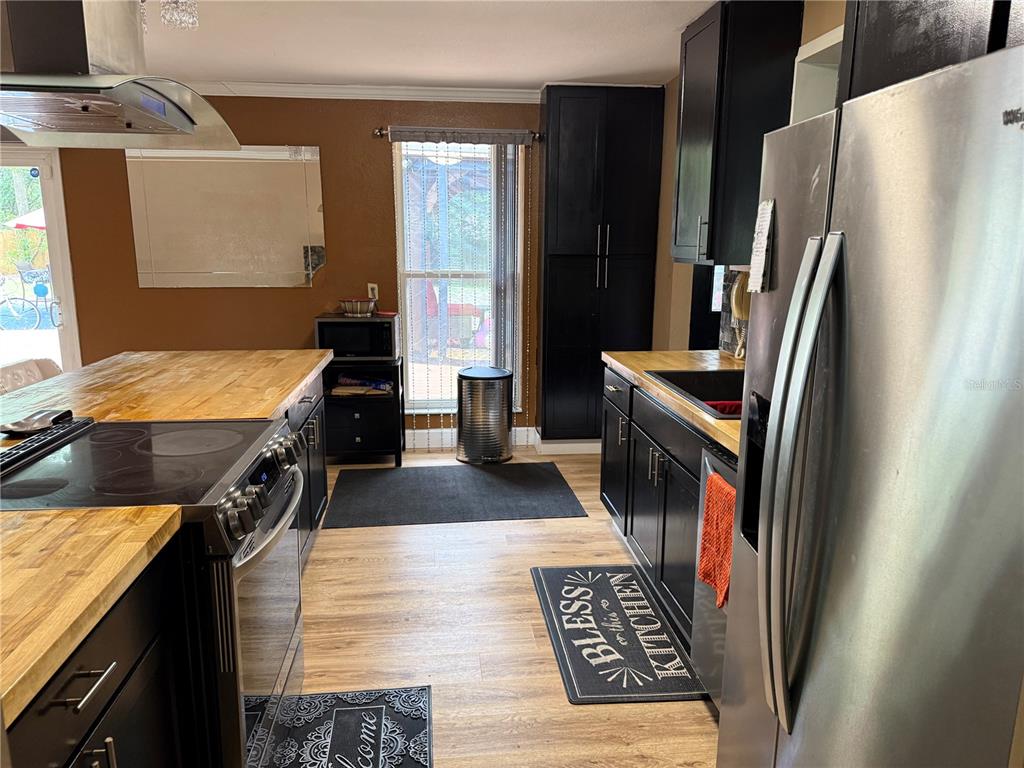 7713 Southwest 8th Avenue Gainesville, FL 32607 - Photo 8 of 32 a kitchen with a sink stove and refrigerator
