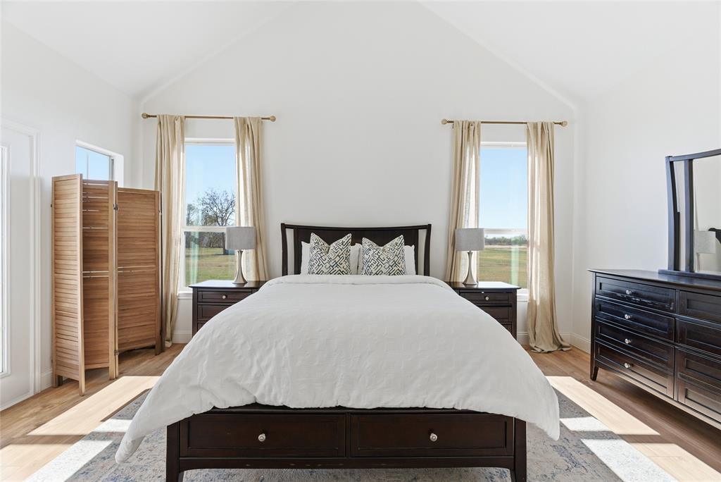 846 Old Tioga Road Gunter, TX 75058 - Photo 11 of 38 a bedroom with a bed and wooden floor
