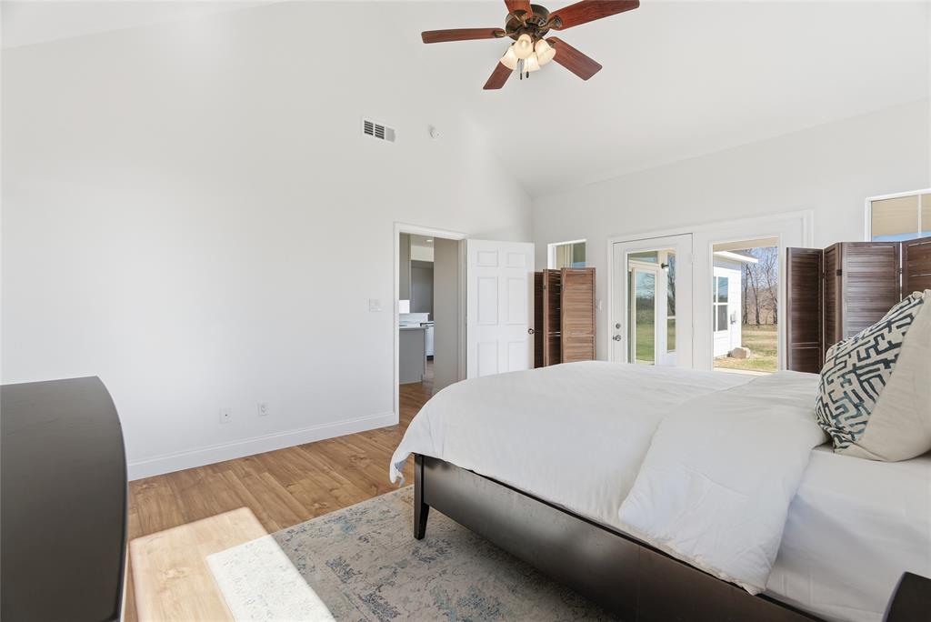 846 Old Tioga Road Gunter, TX 75058 - Photo 12 of 38 a living room with a bed furniture and a large window