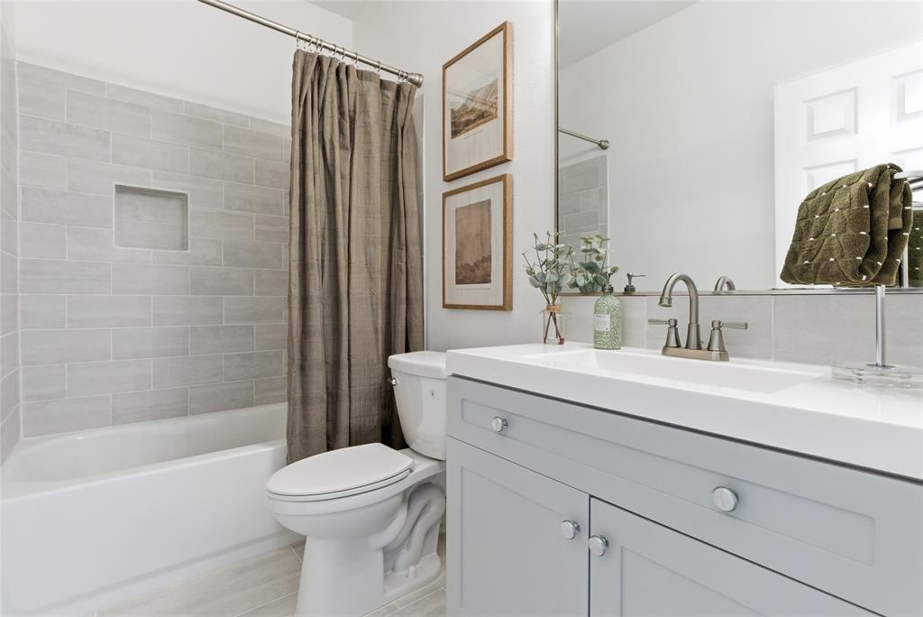 846 Old Tioga Road Gunter, TX 75058 - Photo 16 of 38 a bathroom with a sink a toilet and shower