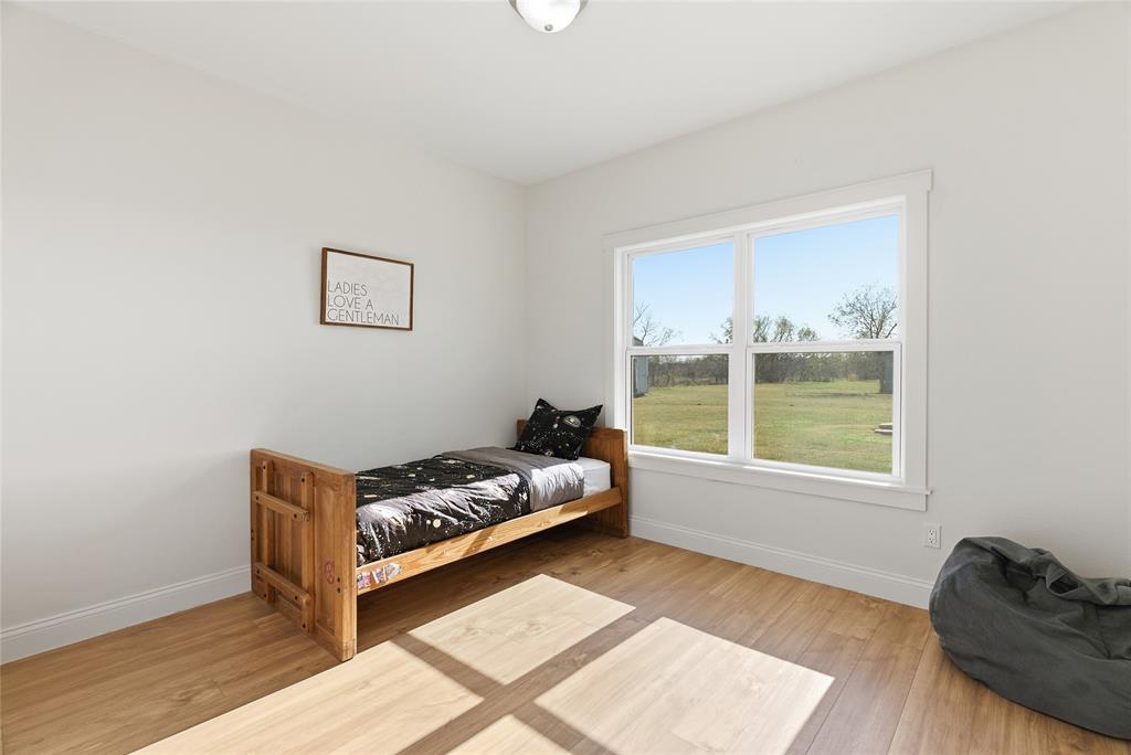 846 Old Tioga Road Gunter, TX 75058 - Photo 17 of 38 a bedroom with furniture and a window