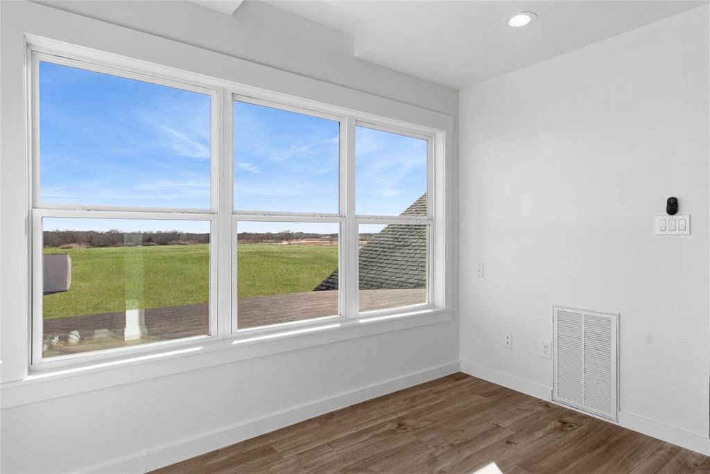 846 Old Tioga Road Gunter, TX 75058 - Photo 19 of 38 an empty room with wooden floor and windows