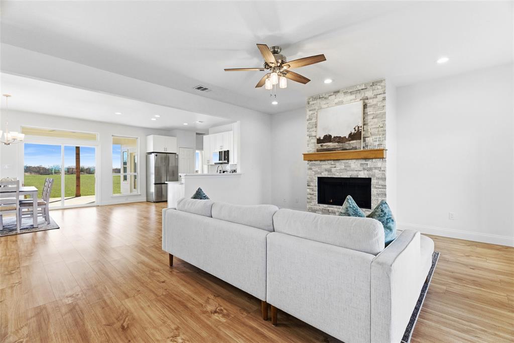 846 Old Tioga Road Gunter, TX 75058 - Photo 4 of 38 a living room with furniture and a fireplace