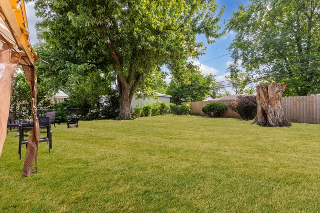 a yard with swimming pool and trees