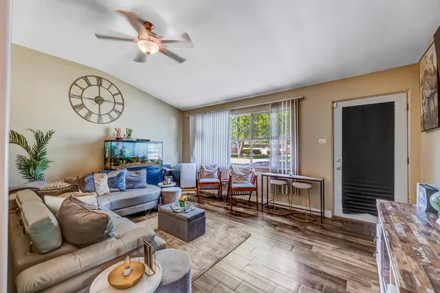 a living room with furniture a fireplace and a window
