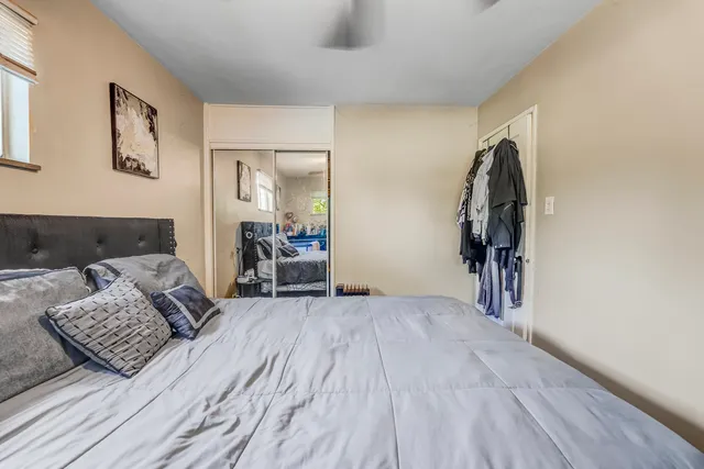 a view of a bedroom with furniture and wooden floor