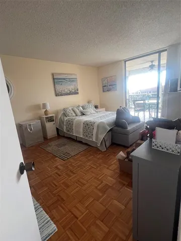 a bedroom with furniture and a large window