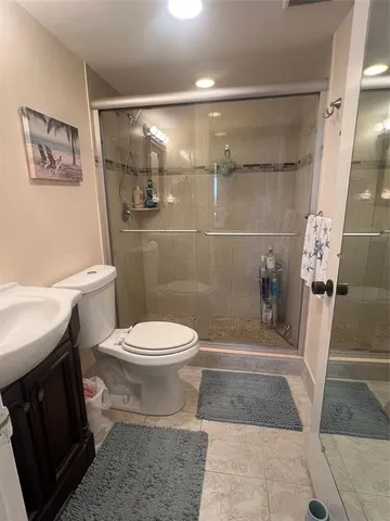a bathroom with a toilet and a shower