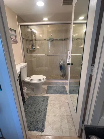 a bathroom with a sink and a glass door shower