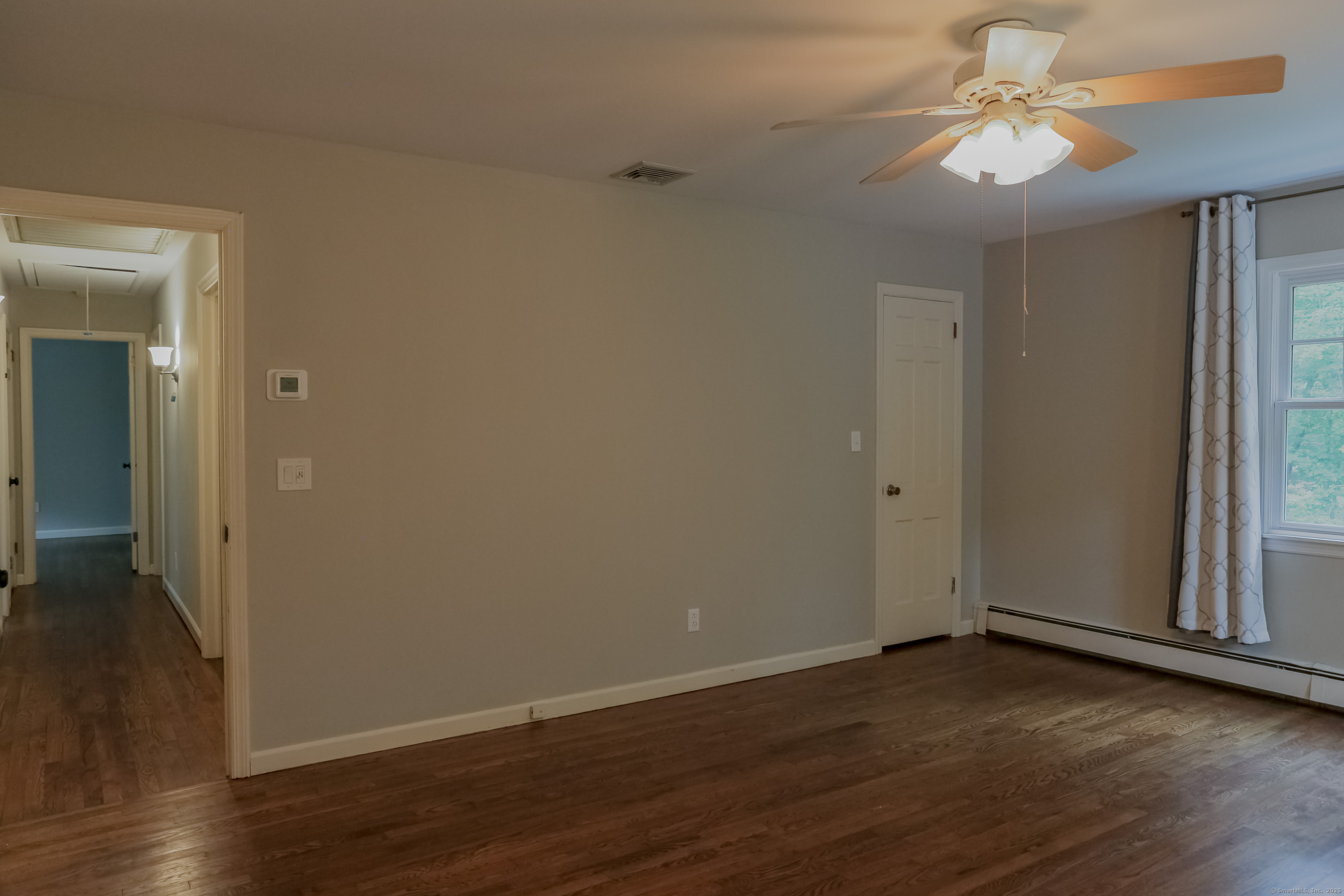 161 Foggwood Road Fairfield, CT 06824 - Photo 12 of 34 a view of a room with wooden floor and a ceiling fan