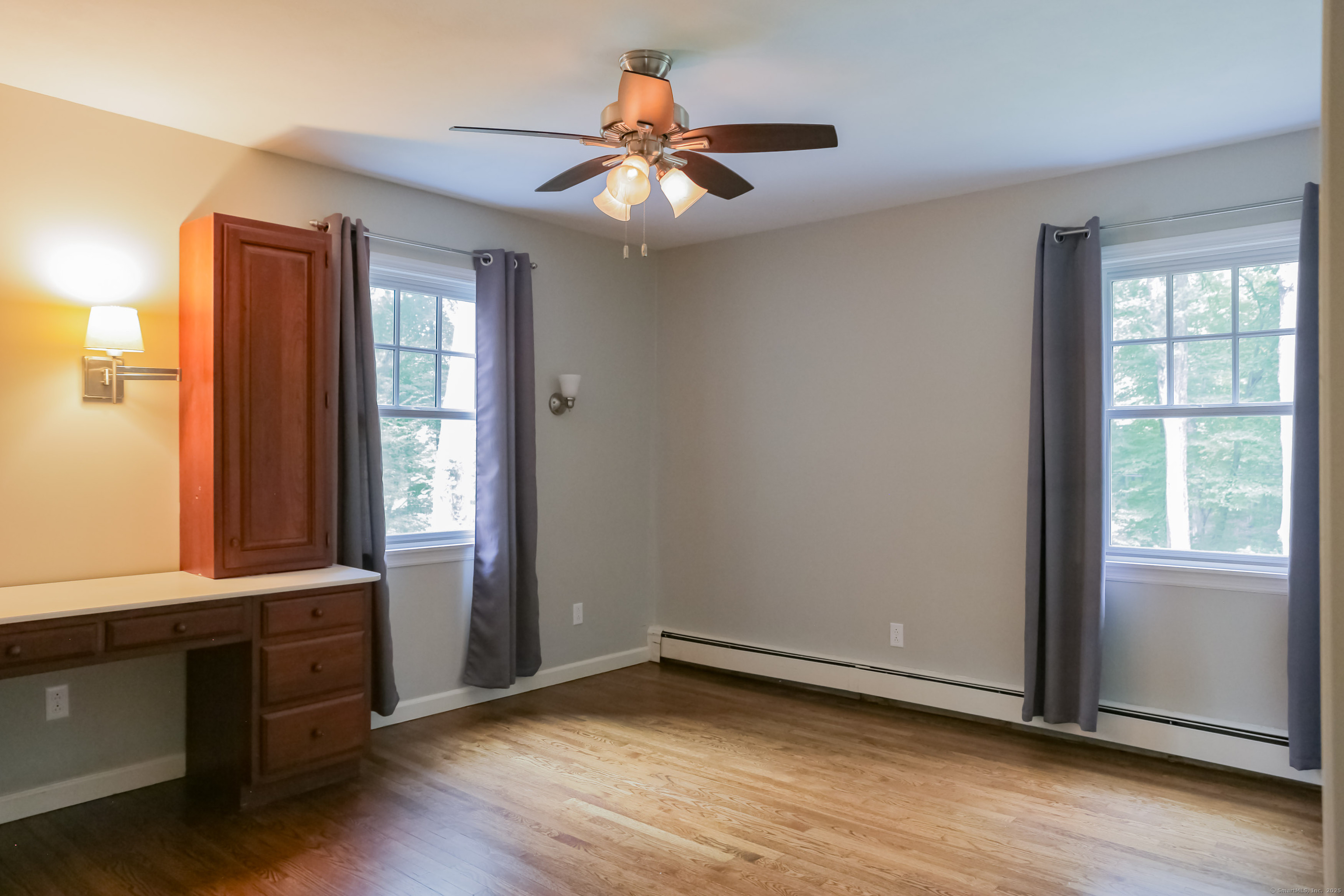 161 Foggwood Road Fairfield, CT 06824 - Photo 19 of 34 an empty room with wooden floor and windows