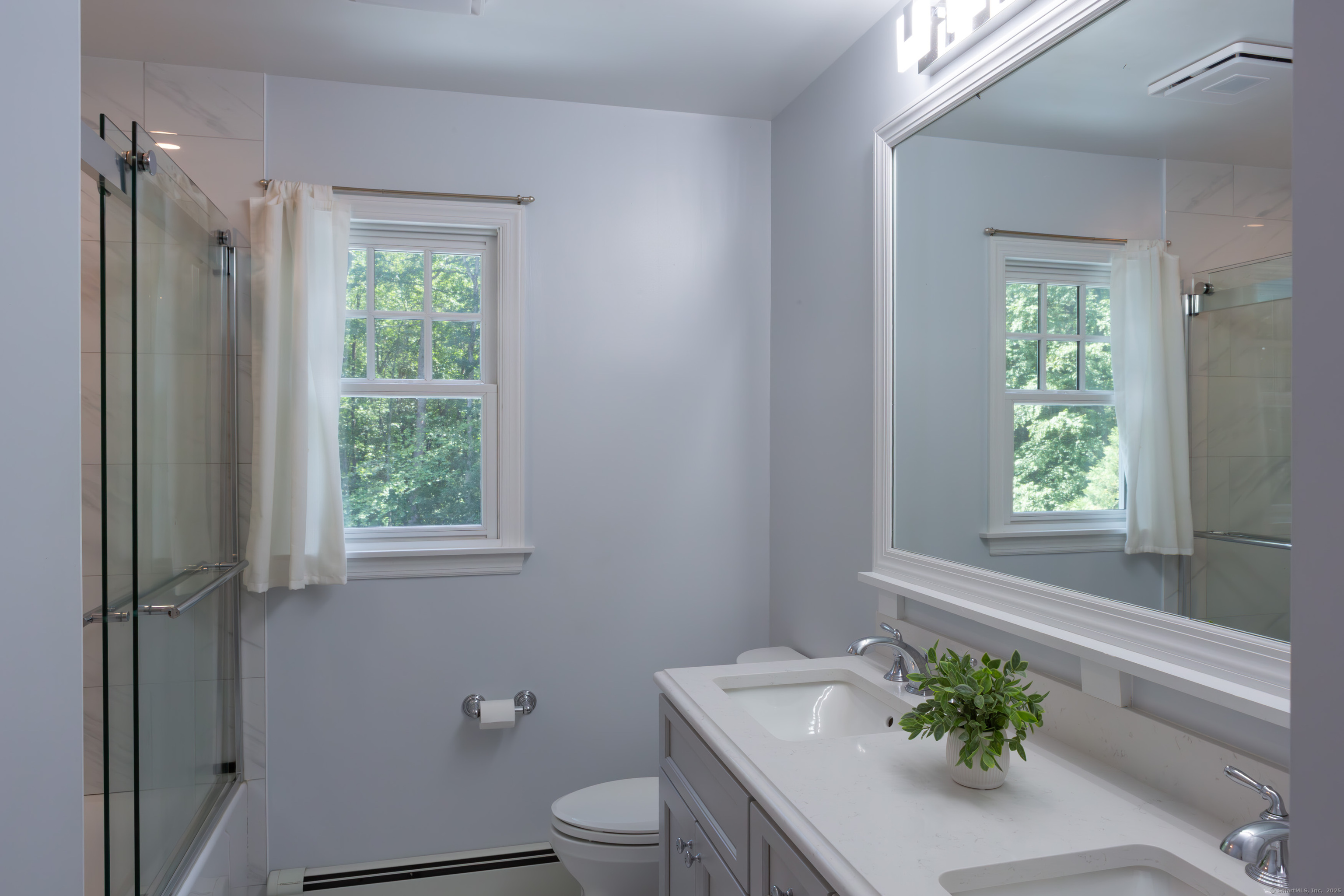 161 Foggwood Road Fairfield, CT 06824 - Photo 22 of 34 a white toilet sitting next to a bathroom sink