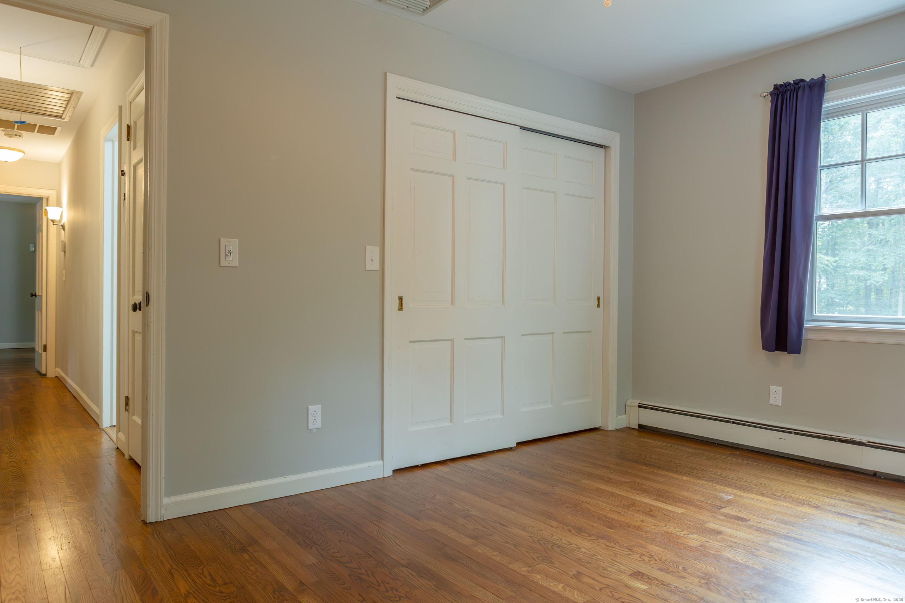 161 Foggwood Road Fairfield, CT 06824 - Photo 24 of 34 an empty room with wooden floor and windows