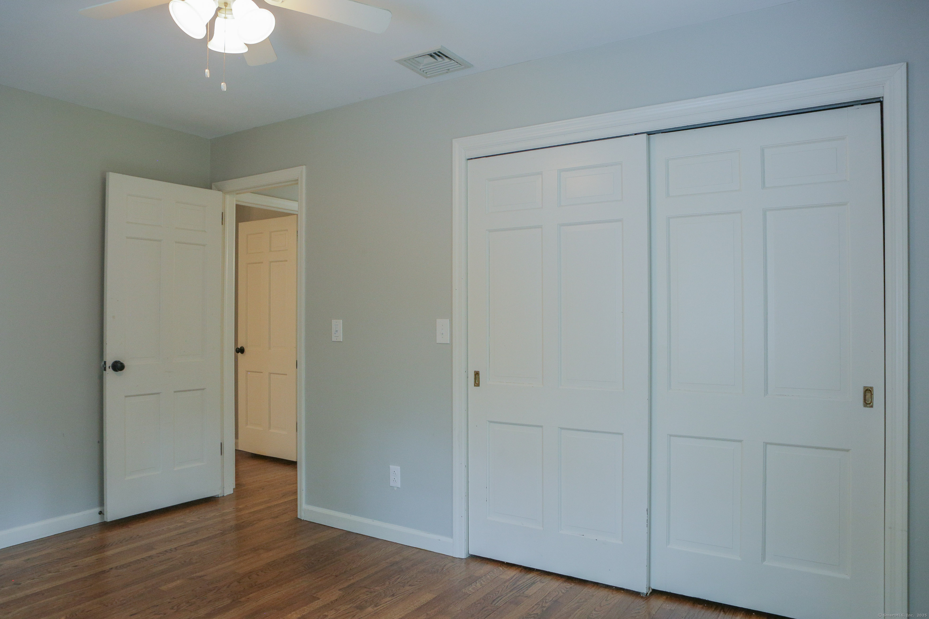 161 Foggwood Road Fairfield, CT 06824 - Photo 26 of 34 a view of an empty room with wooden floor