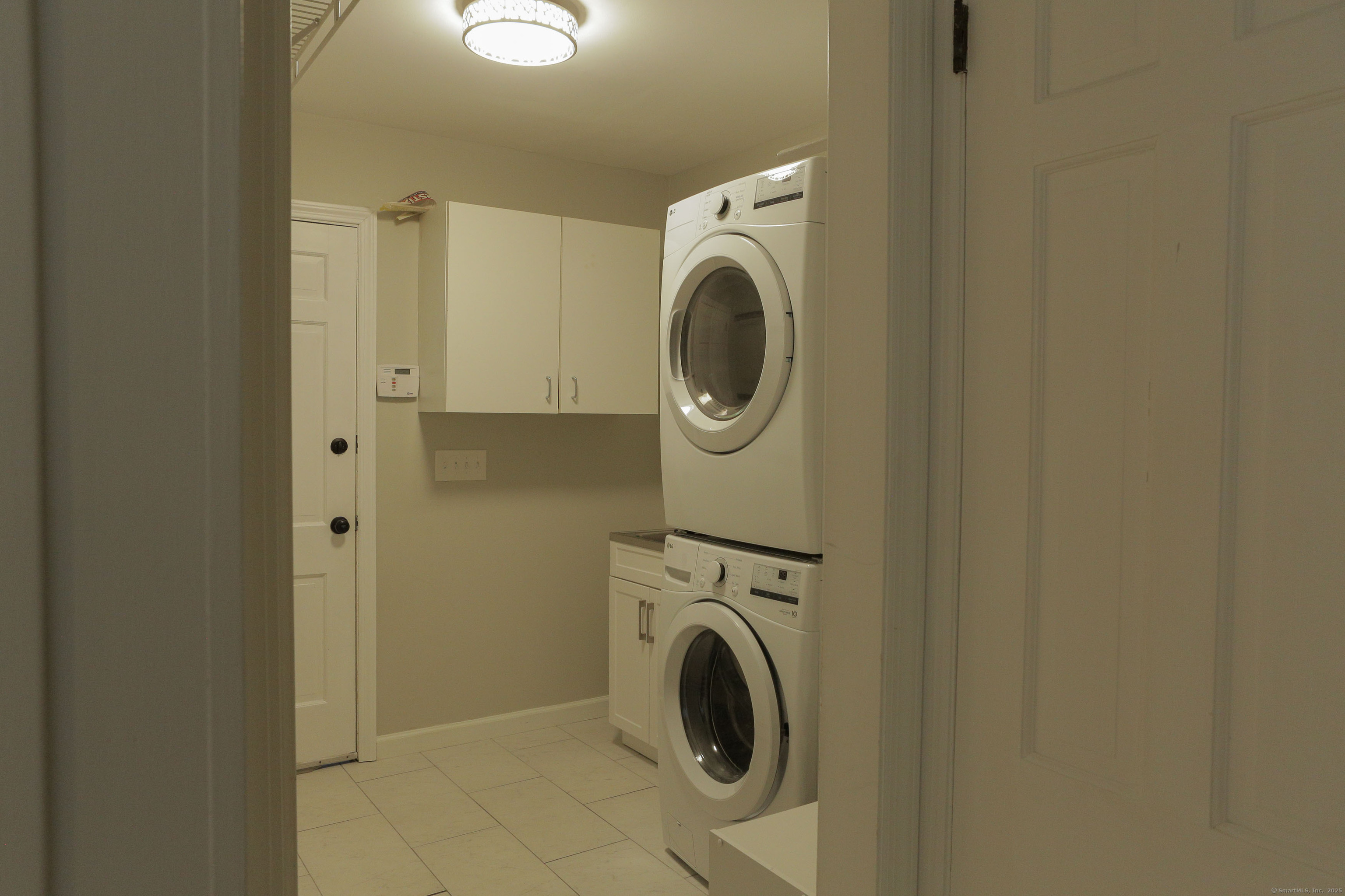 161 Foggwood Road Fairfield, CT 06824 - Photo 30 of 34 a utility room with dryer and washer