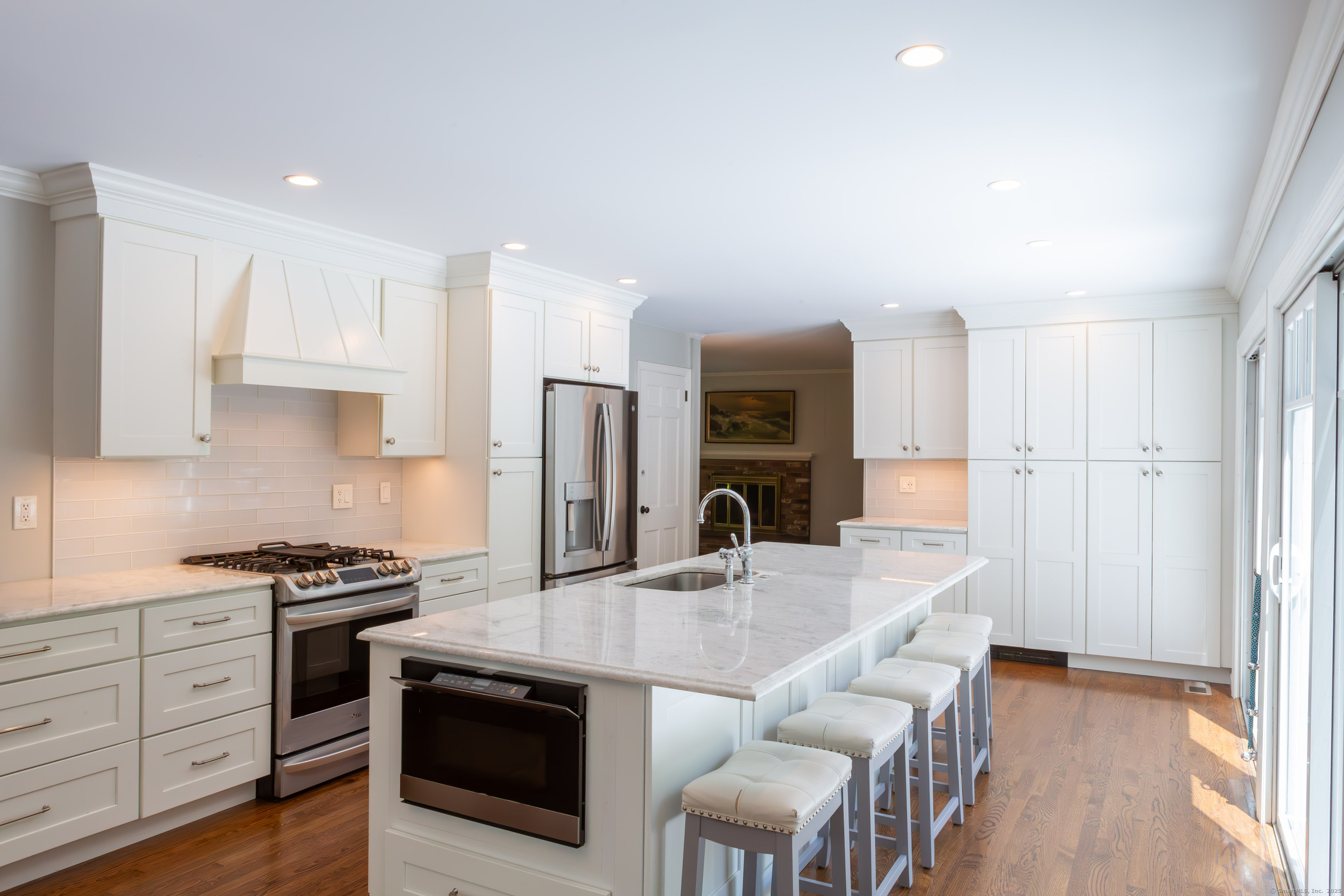 161 Foggwood Road Fairfield, CT 06824 - Photo 5 of 34 a kitchen with stainless steel appliances a stove a sink a microwave a refrigerator and white cabinets