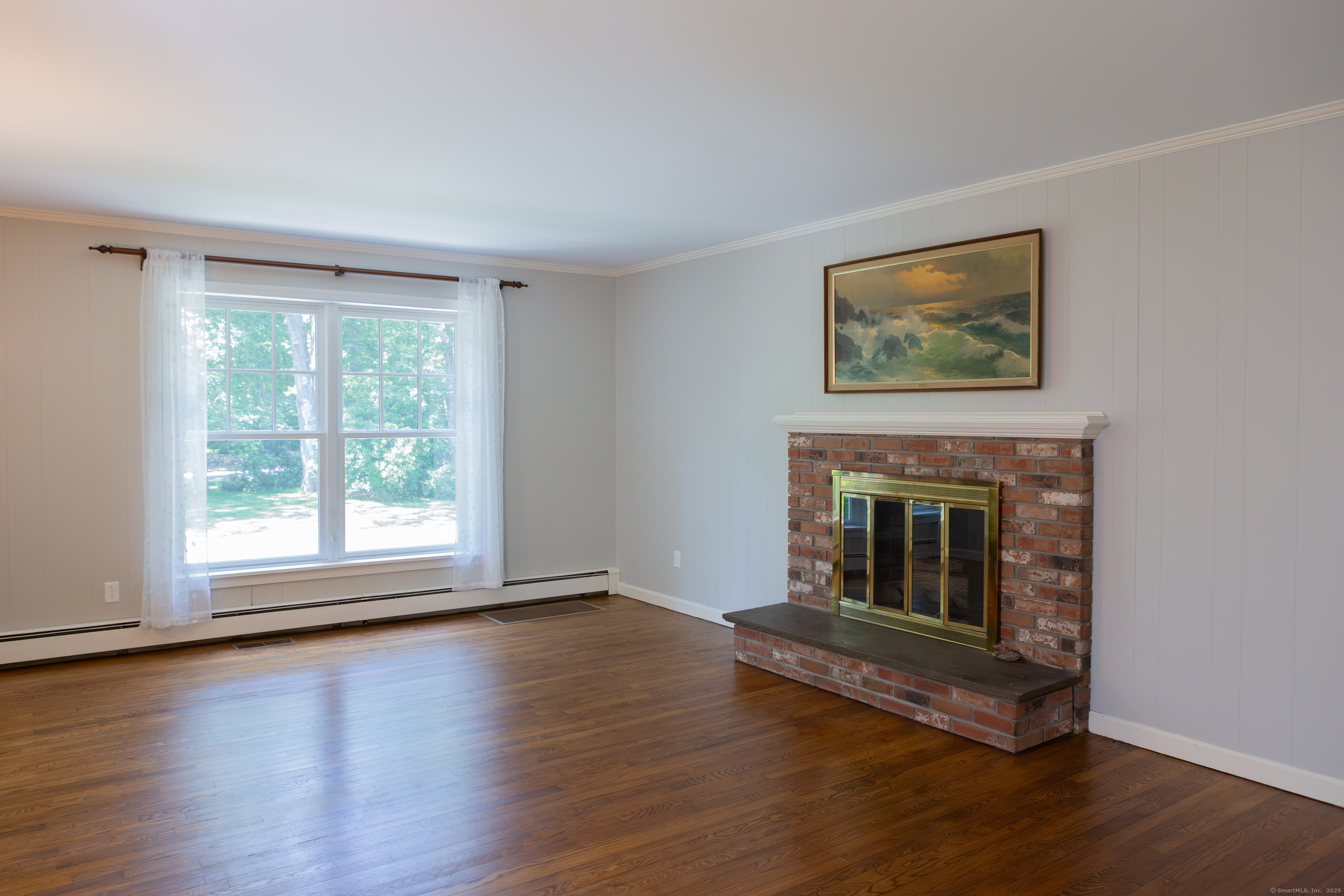 161 Foggwood Road Fairfield, CT 06824 - Photo 9 of 34 a living room with wooden floor and a fireplace