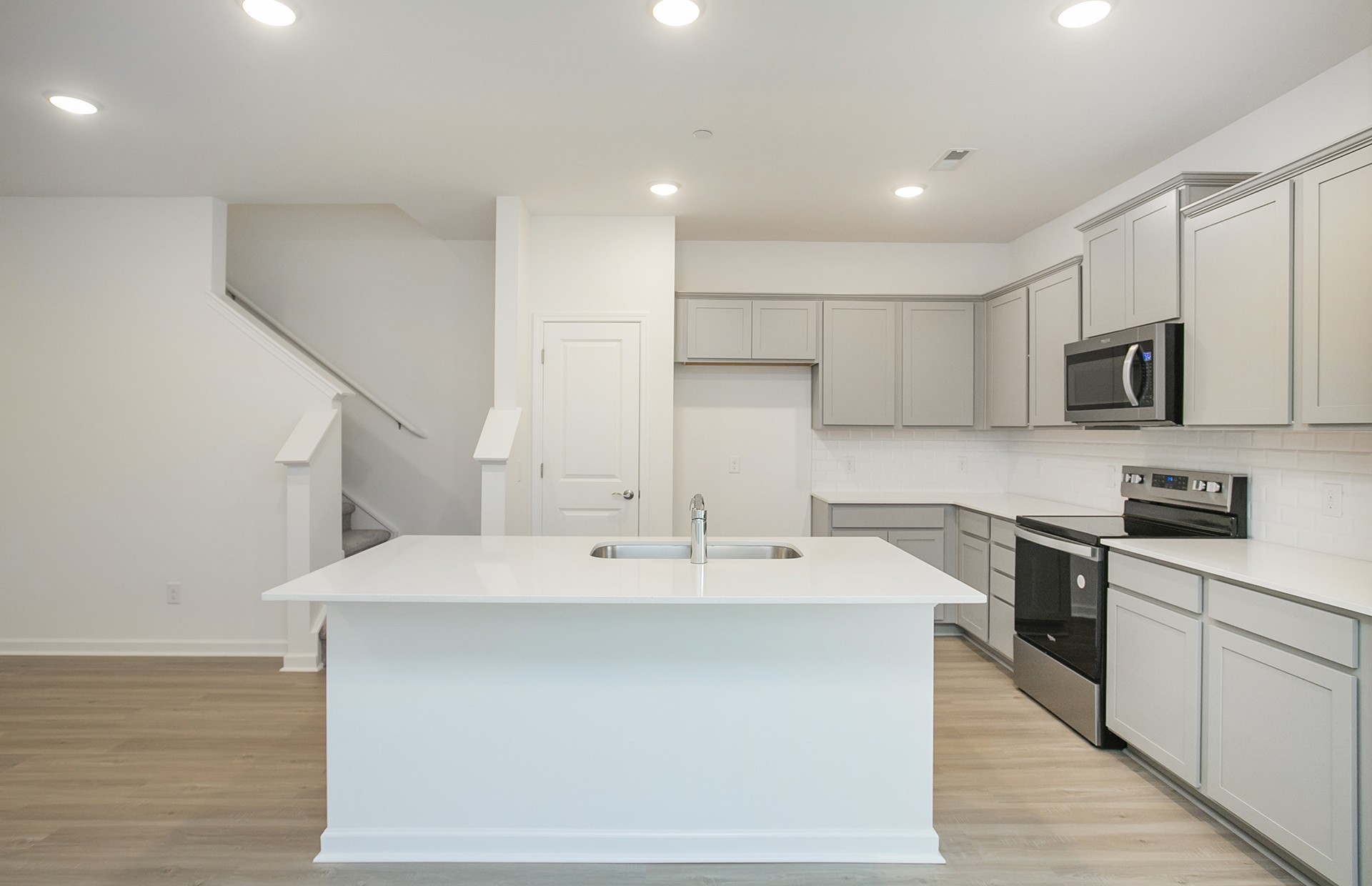 7159 Mapleside Lane Fairview, TN 37062 - Photo 5 of 38 a kitchen with kitchen island a sink stainless steel appliances and cabinets
