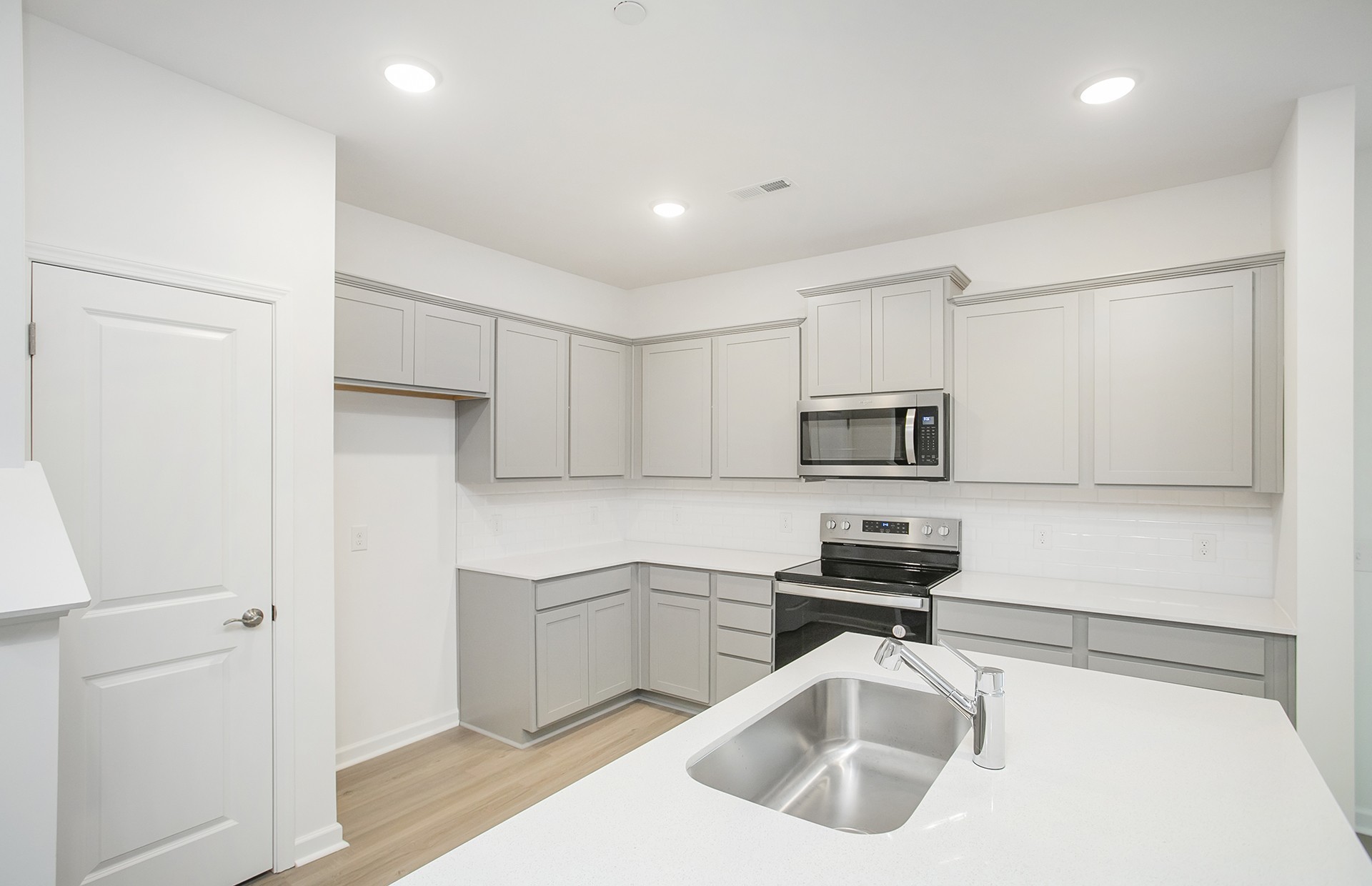 7159 Mapleside Lane Fairview, TN 37062 - Photo 6 of 38 a kitchen with white cabinets and stainless steel appliances