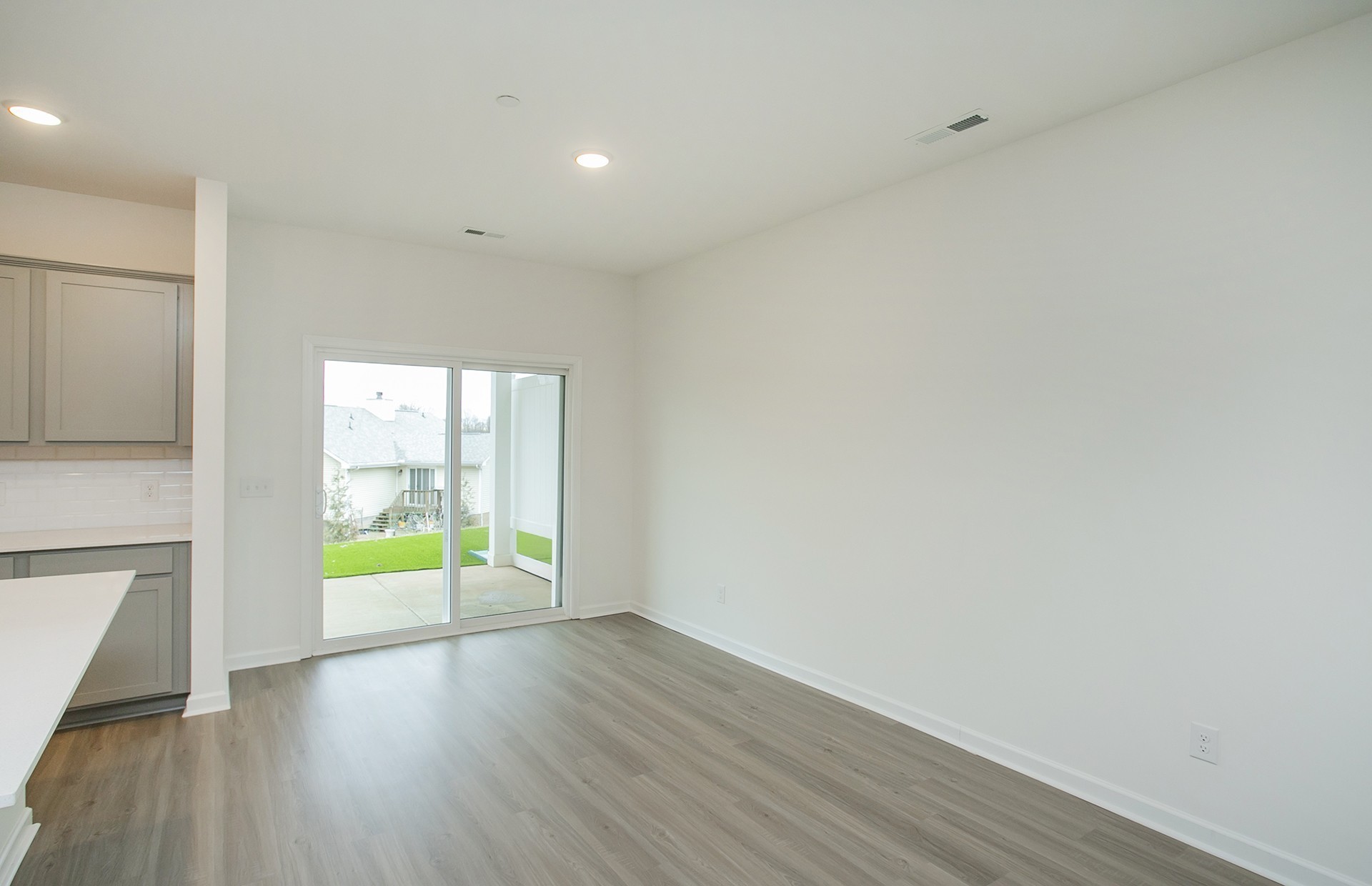 7159 Mapleside Lane Fairview, TN 37062 - Photo 8 of 38 a view of an empty room with a window and wooden floor