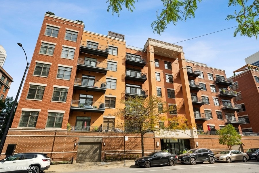 560 West Fulton Street, Unit 504 Chicago, IL 60661 - Photo 1 of 17 a front view of a building with lot of cars and trees