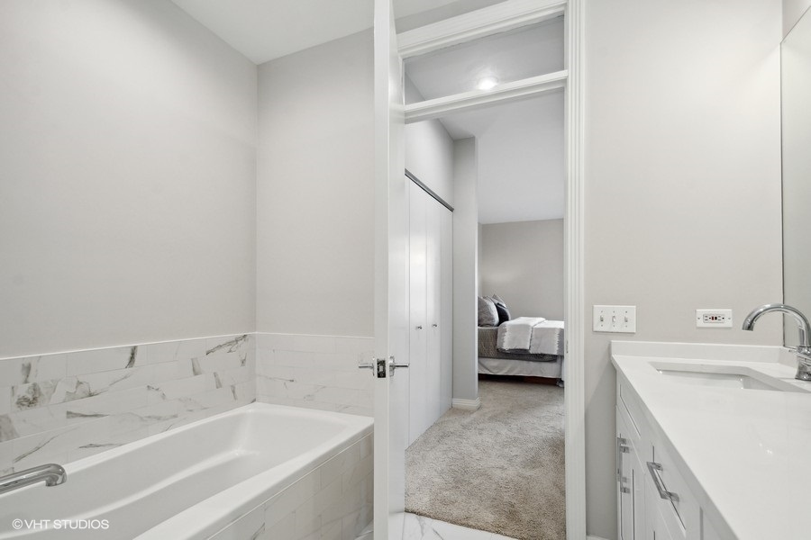 560 West Fulton Street, Unit 504 Chicago, IL 60661 - Photo 12 of 17 a en suite bathroom with a sink and tub