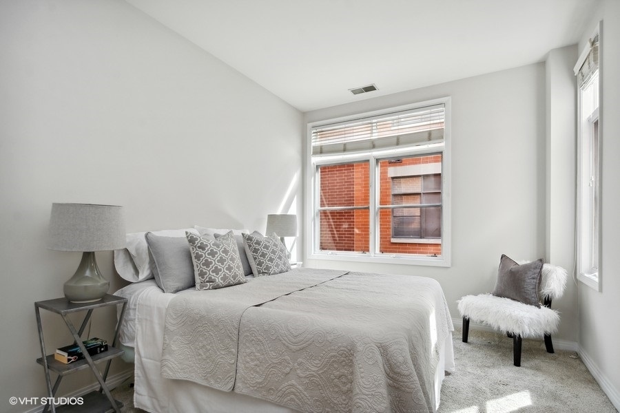 560 West Fulton Street, Unit 504 Chicago, IL 60661 - Photo 13 of 17 a bedroom with bed and a large window