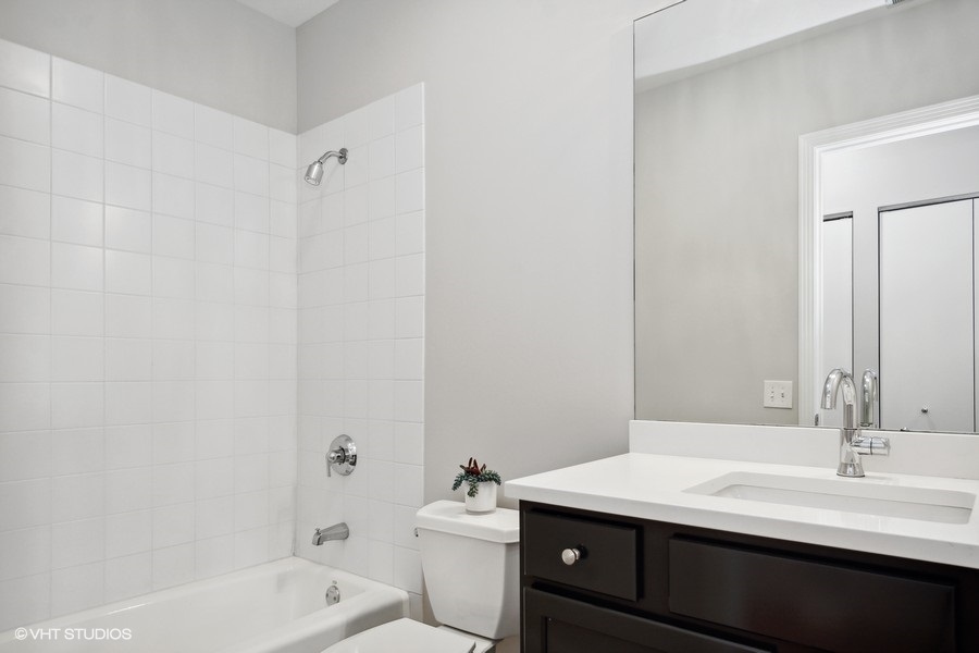 560 West Fulton Street, Unit 504 Chicago, IL 60661 - Photo 15 of 17 a bathroom with a sink a toilet and shower