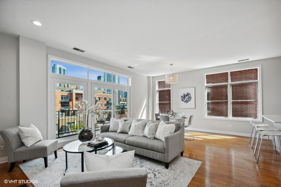 560 West Fulton Street, Unit 504 Chicago, IL 60661 - Photo 2 of 17 a living room with furniture and a large window