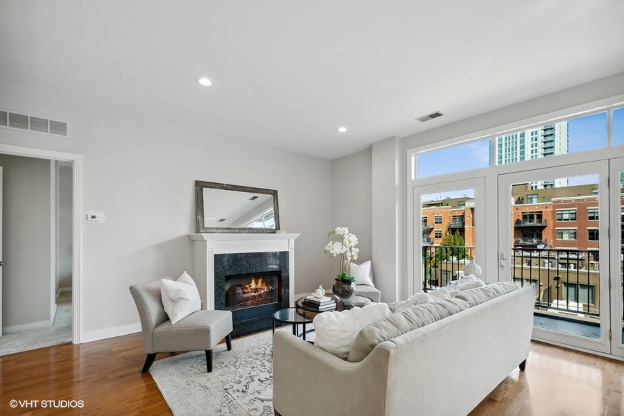 560 West Fulton Street, Unit 504 Chicago, IL 60661 - Photo 3 of 17 a living room with furniture and a fireplace