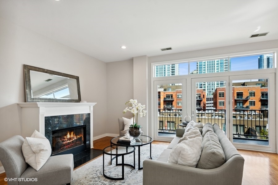 560 West Fulton Street, Unit 504 Chicago, IL 60661 - Photo 5 of 17 a living room with furniture and a fireplace