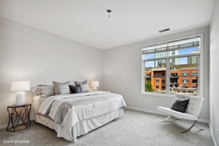 560 West Fulton Street, Unit 504 Chicago, IL 60661 - Photo 9 of 17 a bedroom with a bed and a window
