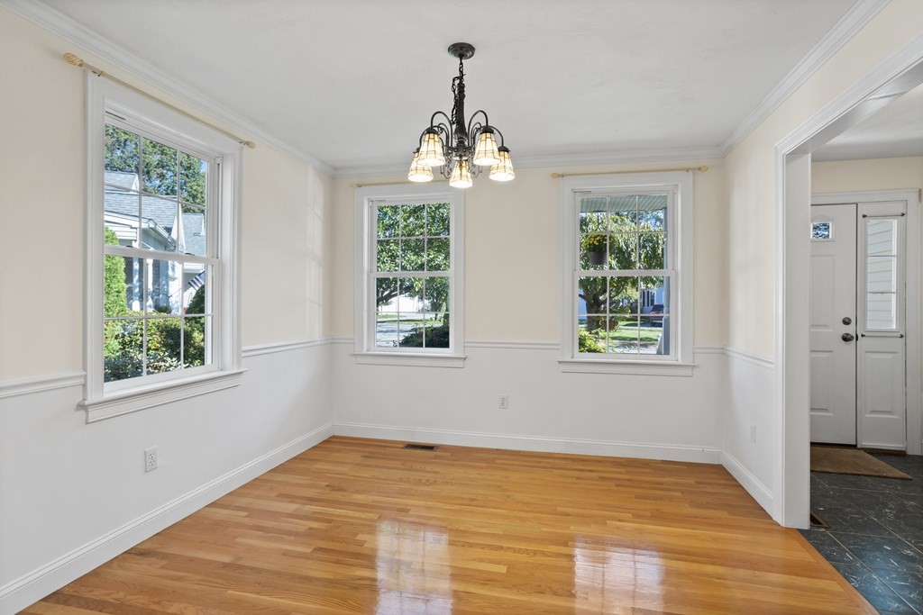 114 Summer Road, Unit 114 Boxborough, MA 01719 - Photo 11 of 42 a view of an empty room with wooden floor and a window