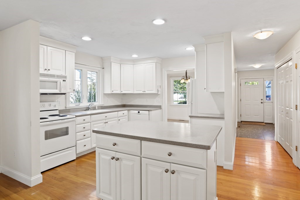 114 Summer Road, Unit 114 Boxborough, MA 01719 - Photo 13 of 42 a kitchen with white cabinets and stainless steel appliances