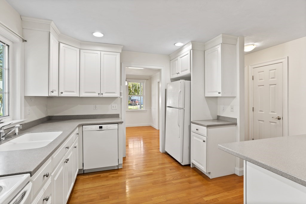 114 Summer Road, Unit 114 Boxborough, MA 01719 - Photo 16 of 42 a kitchen with white cabinets and refrigerator