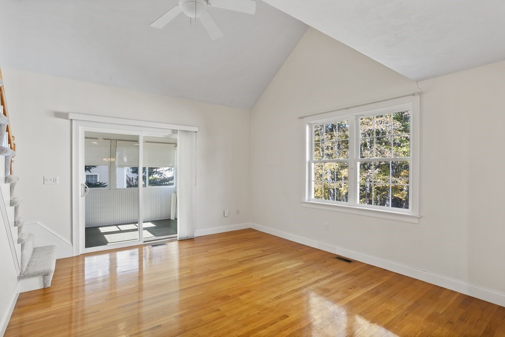 114 Summer Road, Unit 114 Boxborough, MA 01719 - Photo 18 of 42 a view of an empty room with window and wooden floor